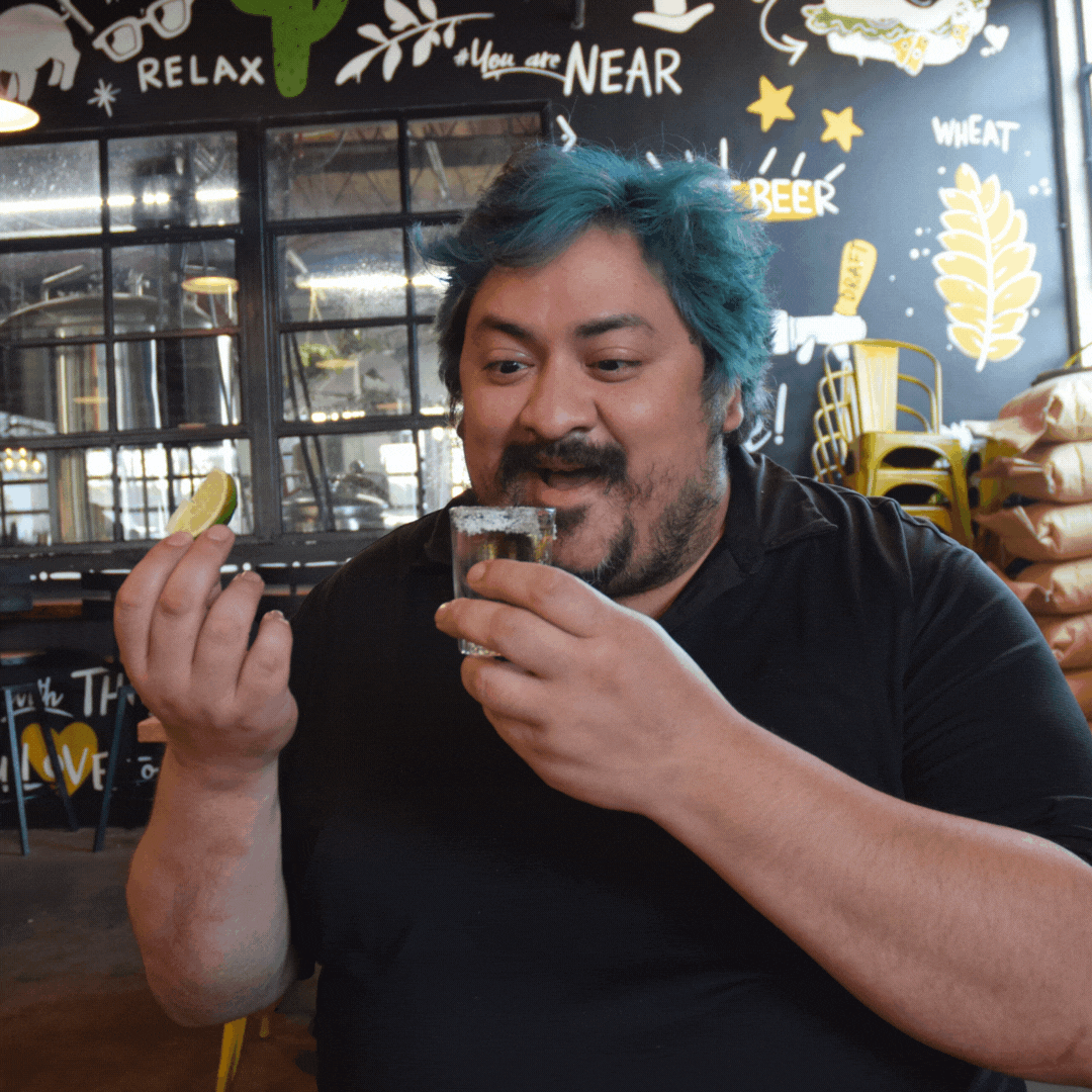GIF of guy taking a tequila shot and eating lime